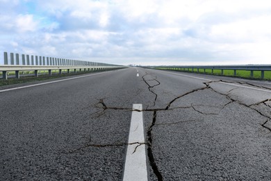 Large cracks on asphalt road after earthquake