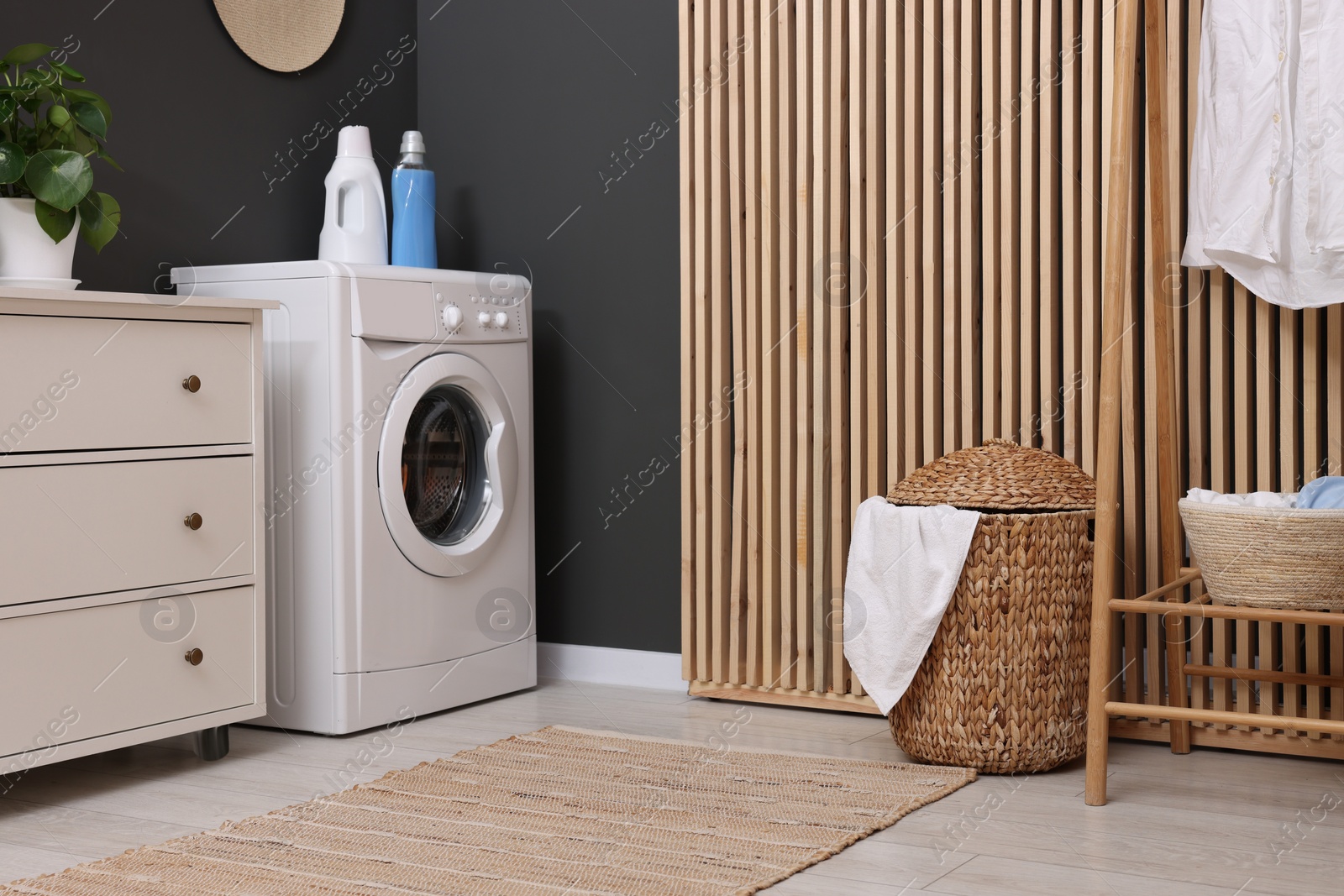 Photo of Laundry room interior with washing machine and furniture