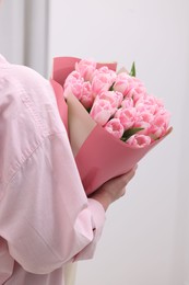 Photo of Woman with bouquet of beautiful fresh tulips on blurred background, closeup