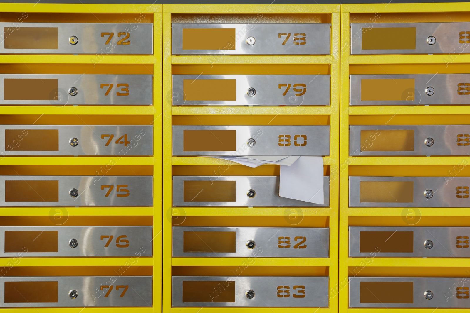 Photo of Metal mailboxes with receipts from post office indoors