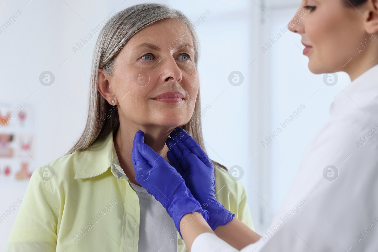 Photo of Endocrinologist examining thyroid gland of patient at hospital