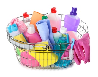 Metal shopping basket with different household chemicals on white background