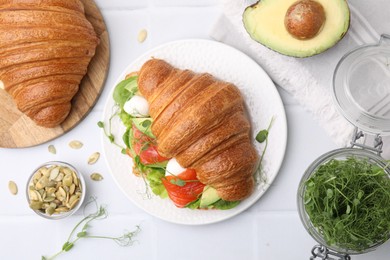 Photo of Flat lay composition with tasty croissants and products on white table