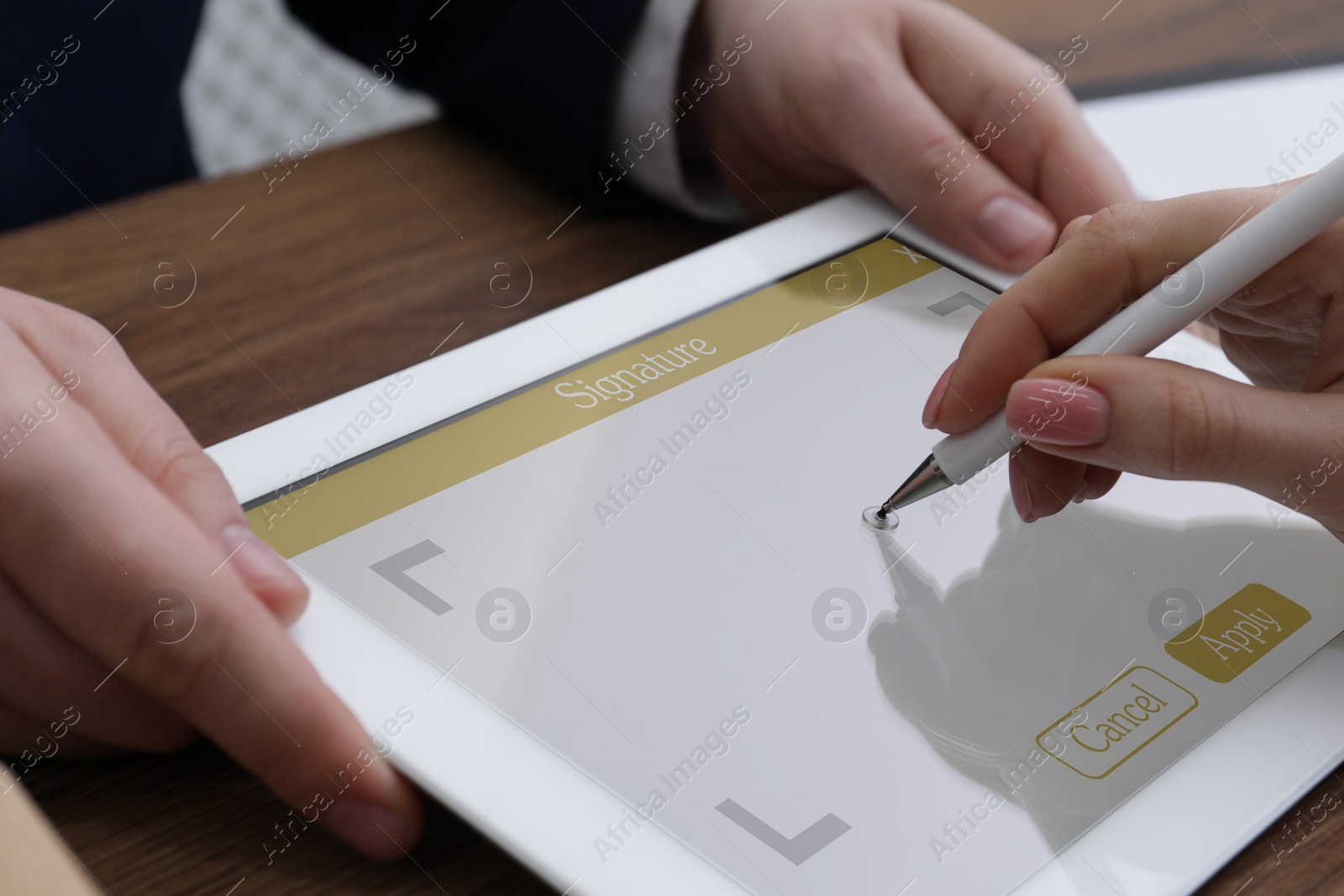 Image of Electronic signature. Woman using stylus and tablet at wooden table, closeup