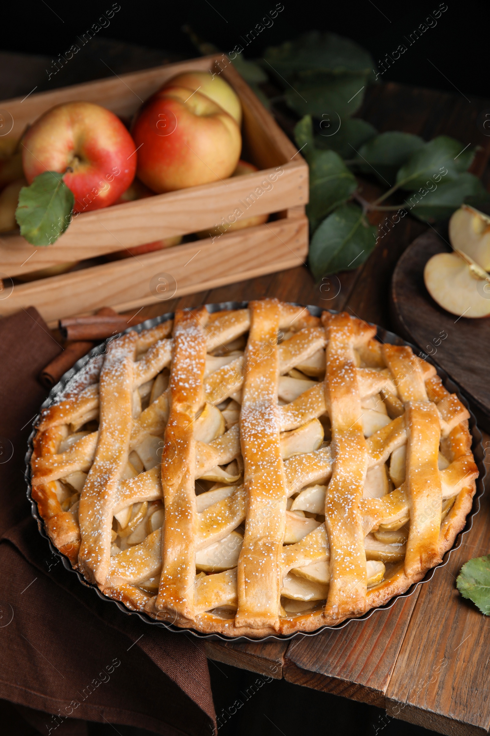 Photo of Delicious traditional apple pie on wooden table