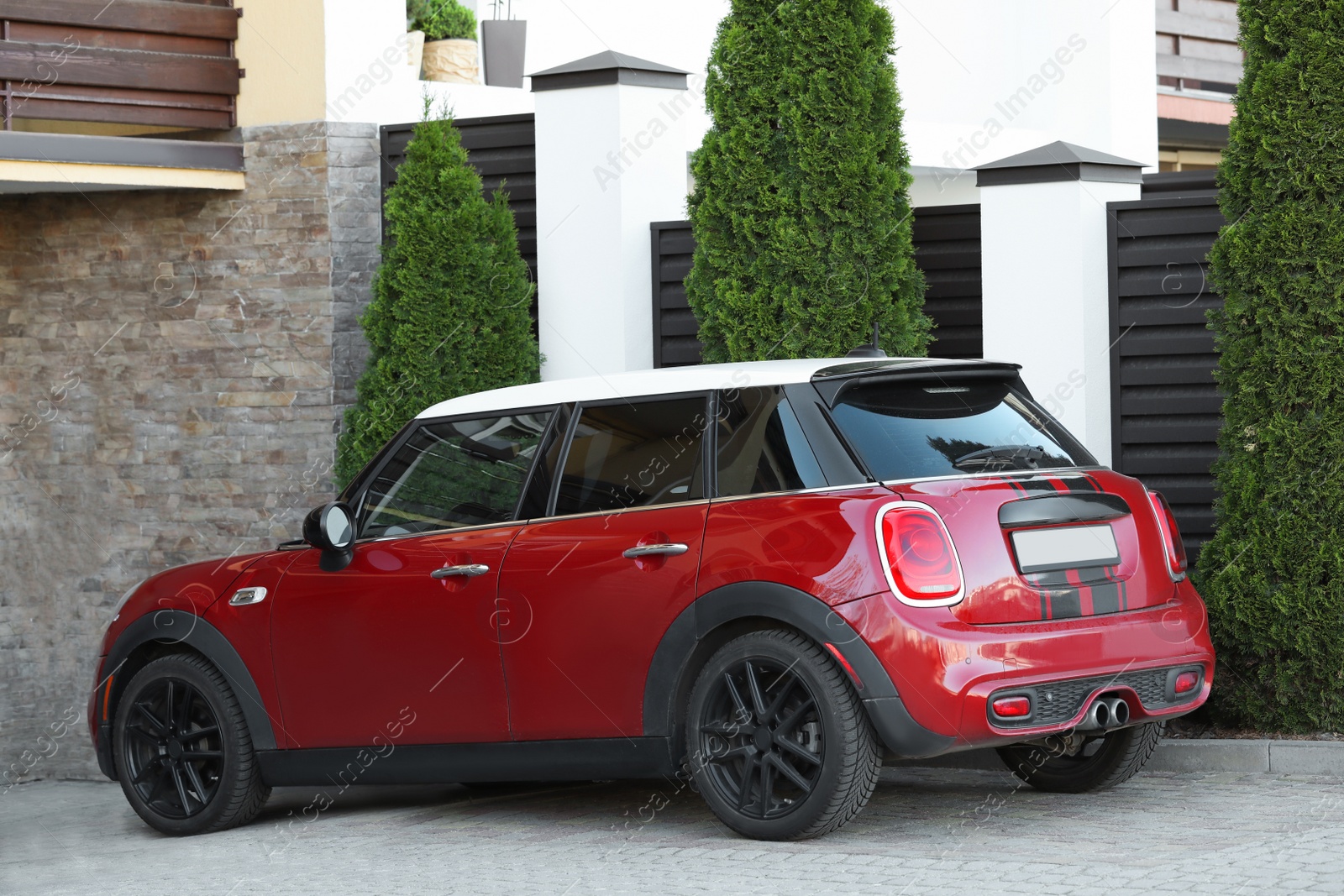 Photo of Lviv, Ukraine - May 10, 2022: Red Mini Cooper S parked outdoors