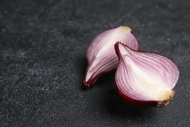 Photo of Ripe cut red onion on table