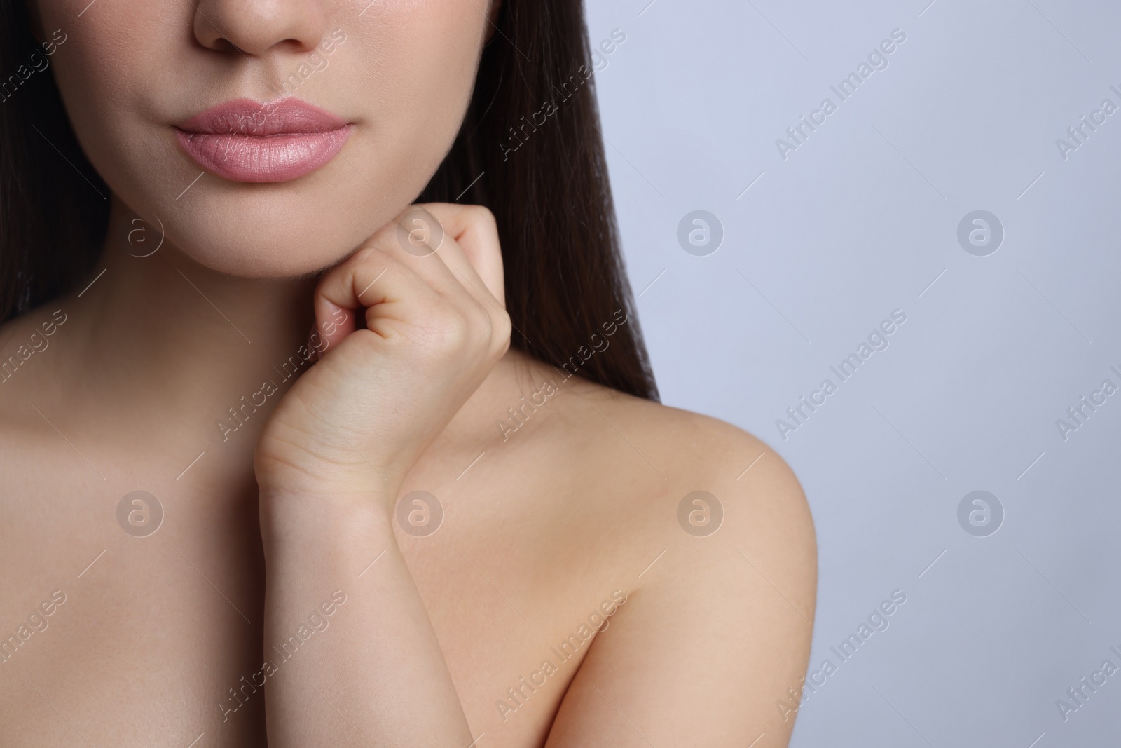 Photo of Closeup view of woman with beautiful full lips on grey background. Space for text