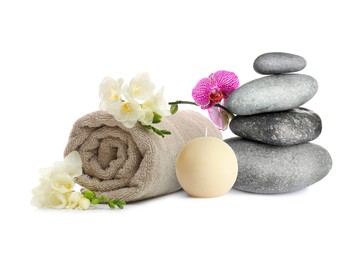 Image of Beautiful composition with rolled towel, flowers and stacked stones on white background. Spa therapy