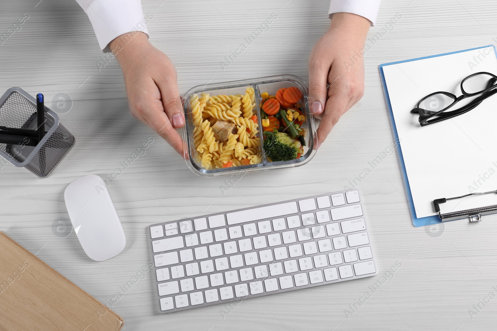 Photo of Office employee having business lunch at workplace, top view