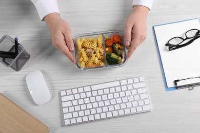 Photo of Office employee having business lunch at workplace, top view