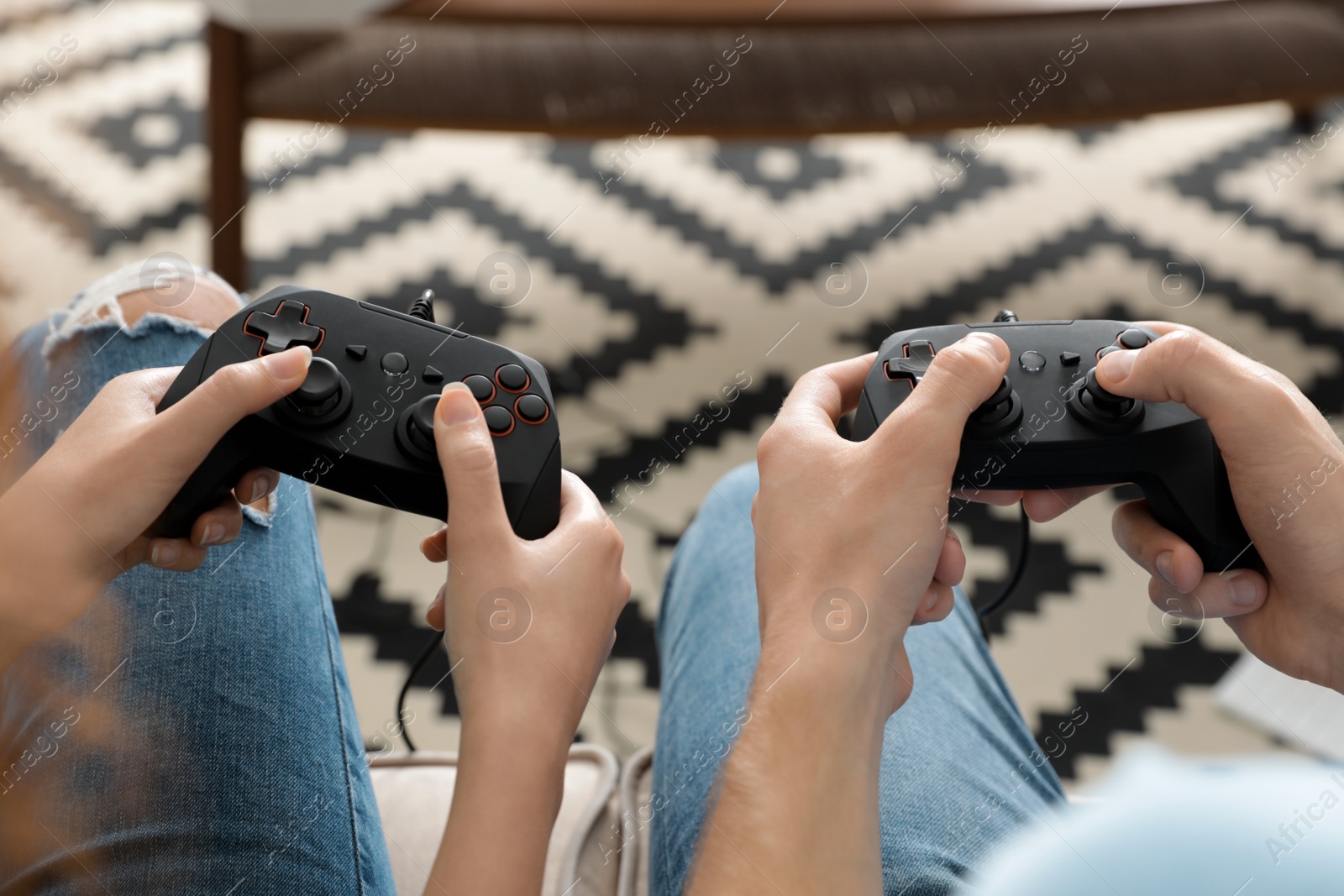 Photo of Young couple playing video games at home, closeup