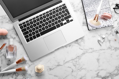 Photo of Flat lay composition with laptop on marble table. Beauty blogger's workplace