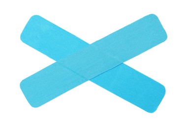 Light blue kinesio tape pieces on white background, top view