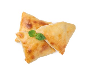 Delicious samosas and basil isolated on white, top view