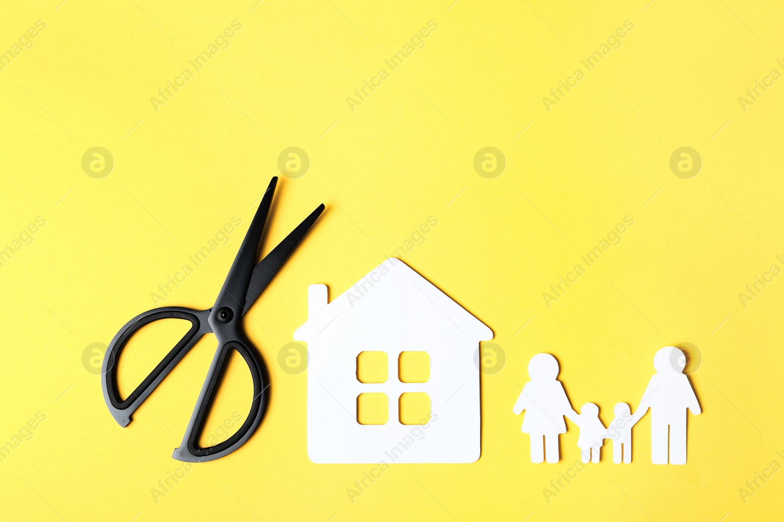 Photo of Flat lay composition with paper silhouette of family and scissors on color background. Life insurance concept