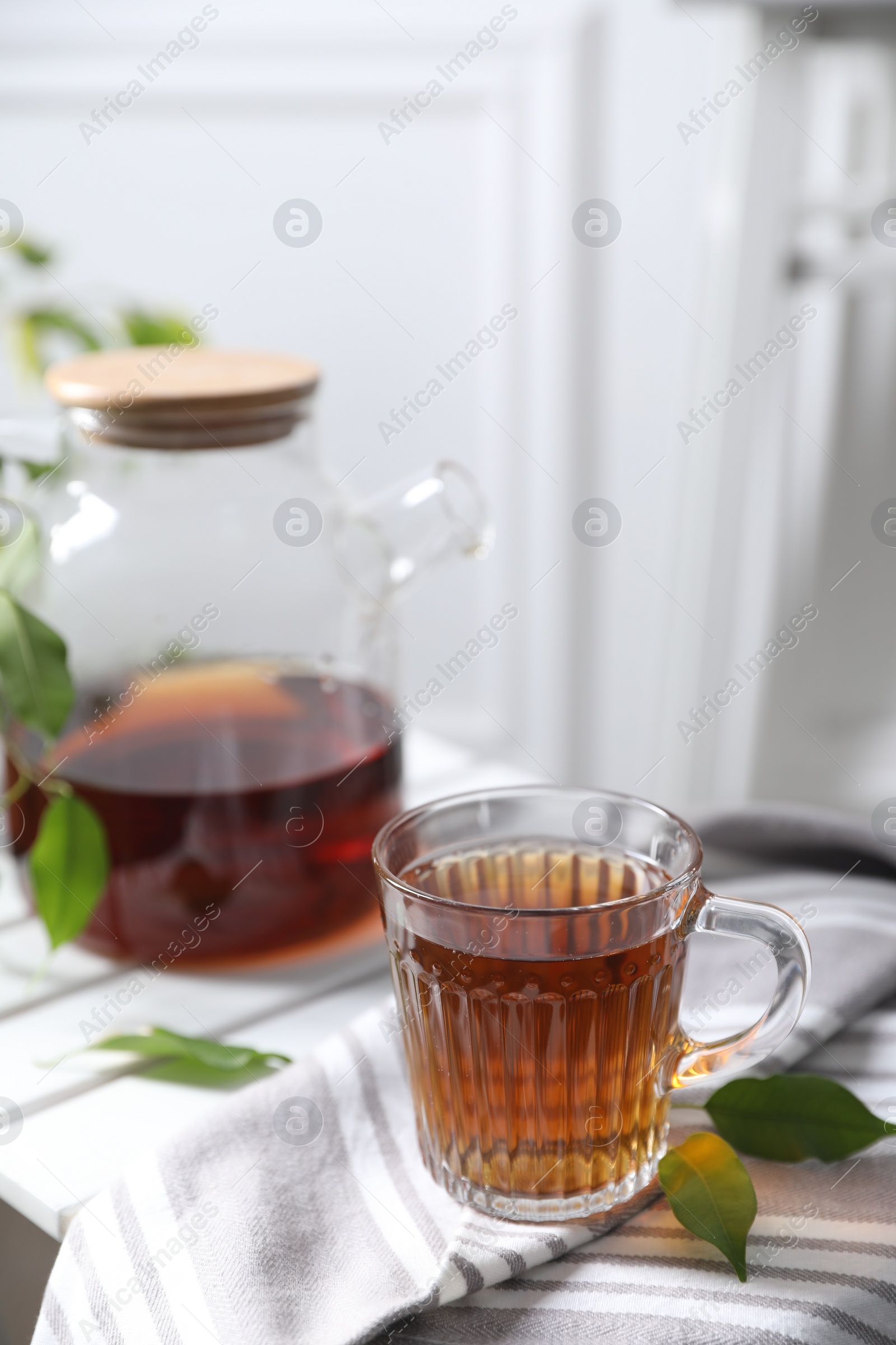 Photo of Tasty warm tea in cup on table, closeup