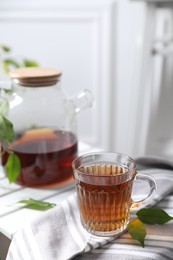 Photo of Tasty warm tea in cup on table, closeup