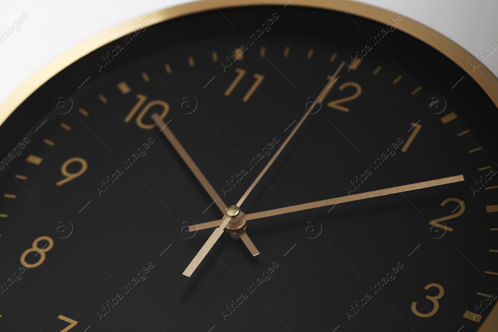 Photo of Stylish round clock on white background, closeup. Interior element