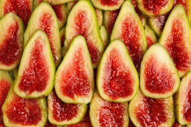 Pieces of fresh green figs as background, top view