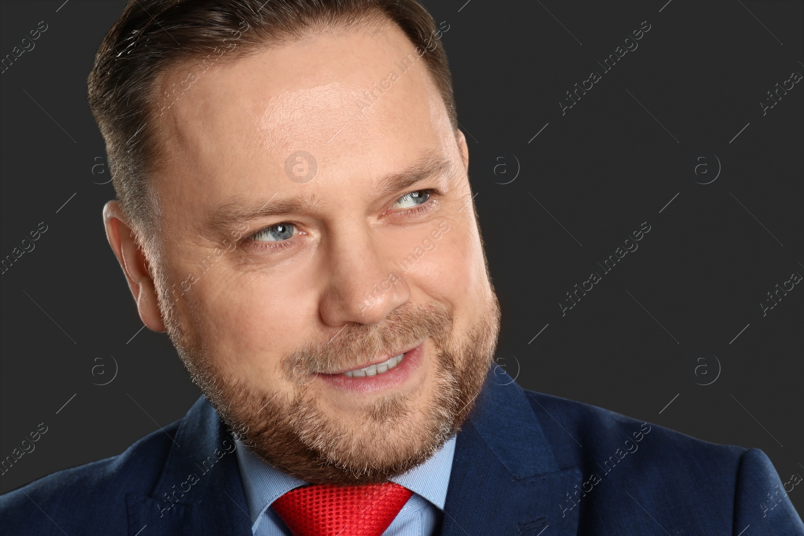 Photo of Portrait of mature man on black background