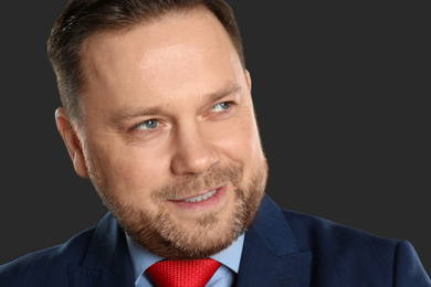 Photo of Portrait of mature man on black background