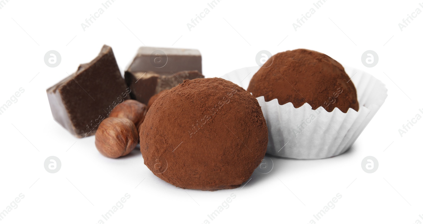 Photo of Delicious chocolate truffles with ingredients on white background