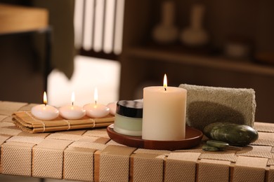 Beautiful composition with different spa products on wicker bench indoors