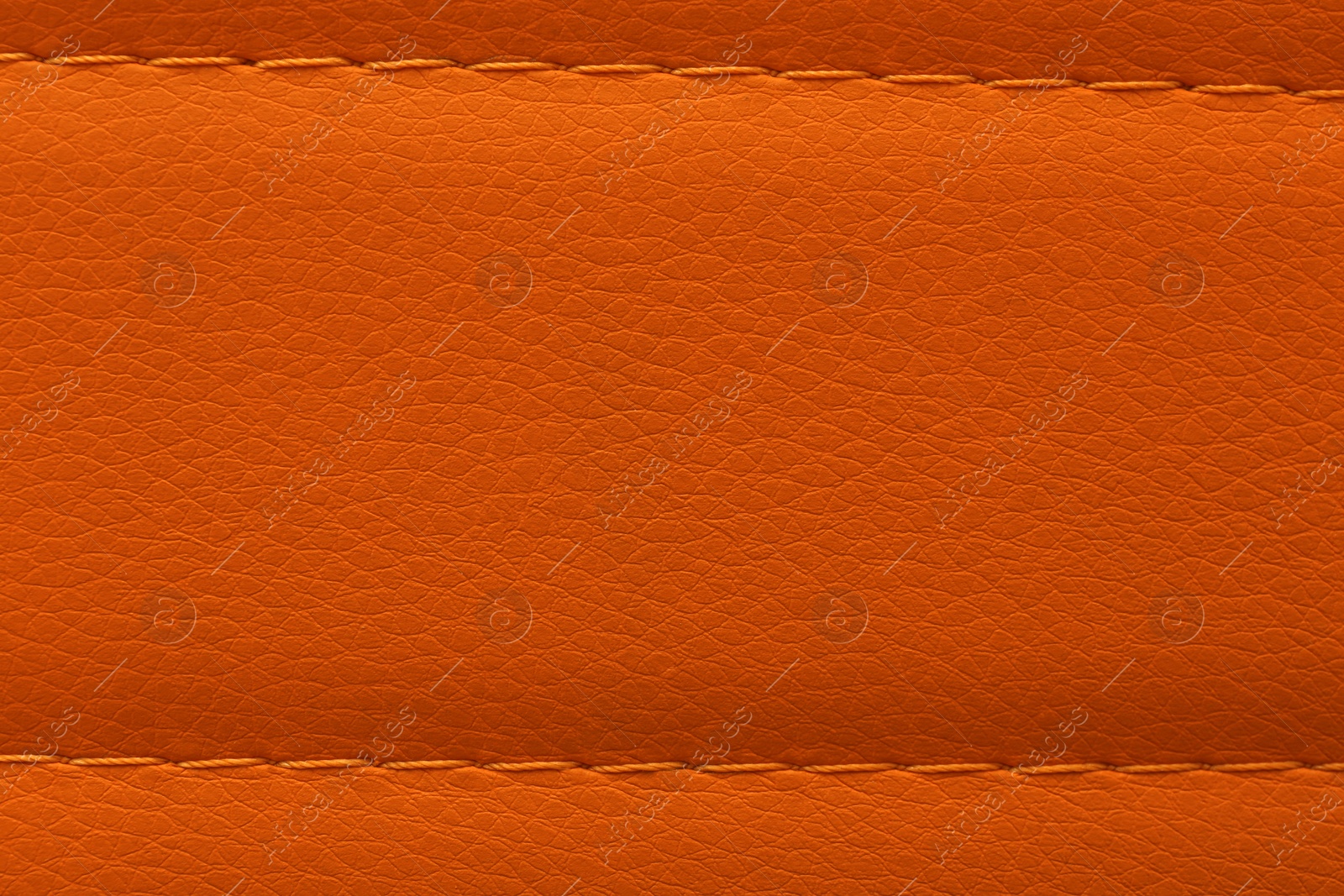 Photo of Texture of orange leather as background, top view