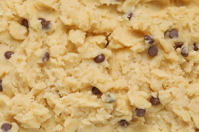 Photo of Raw dough for chocolate chip cookies as background, top view