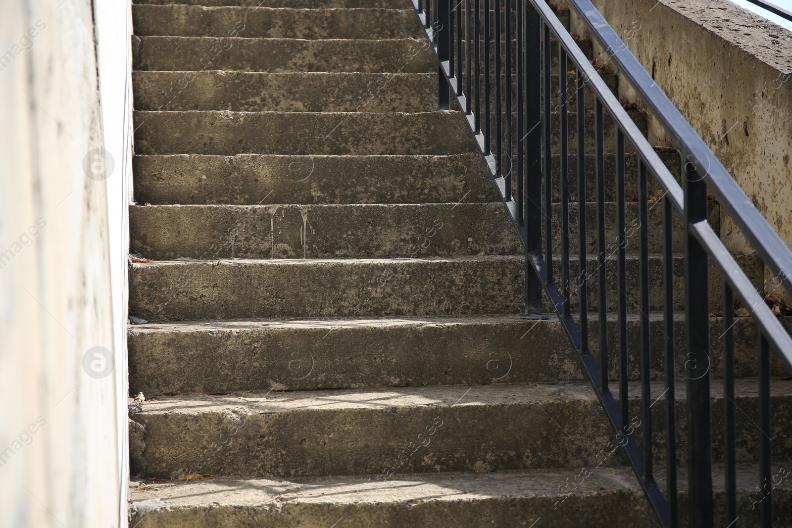 Photo of View of beautiful concrete stairs with metal handrail outdoors