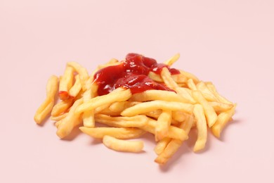 Photo of Tasty french fries with ketchup on pink background, closeup