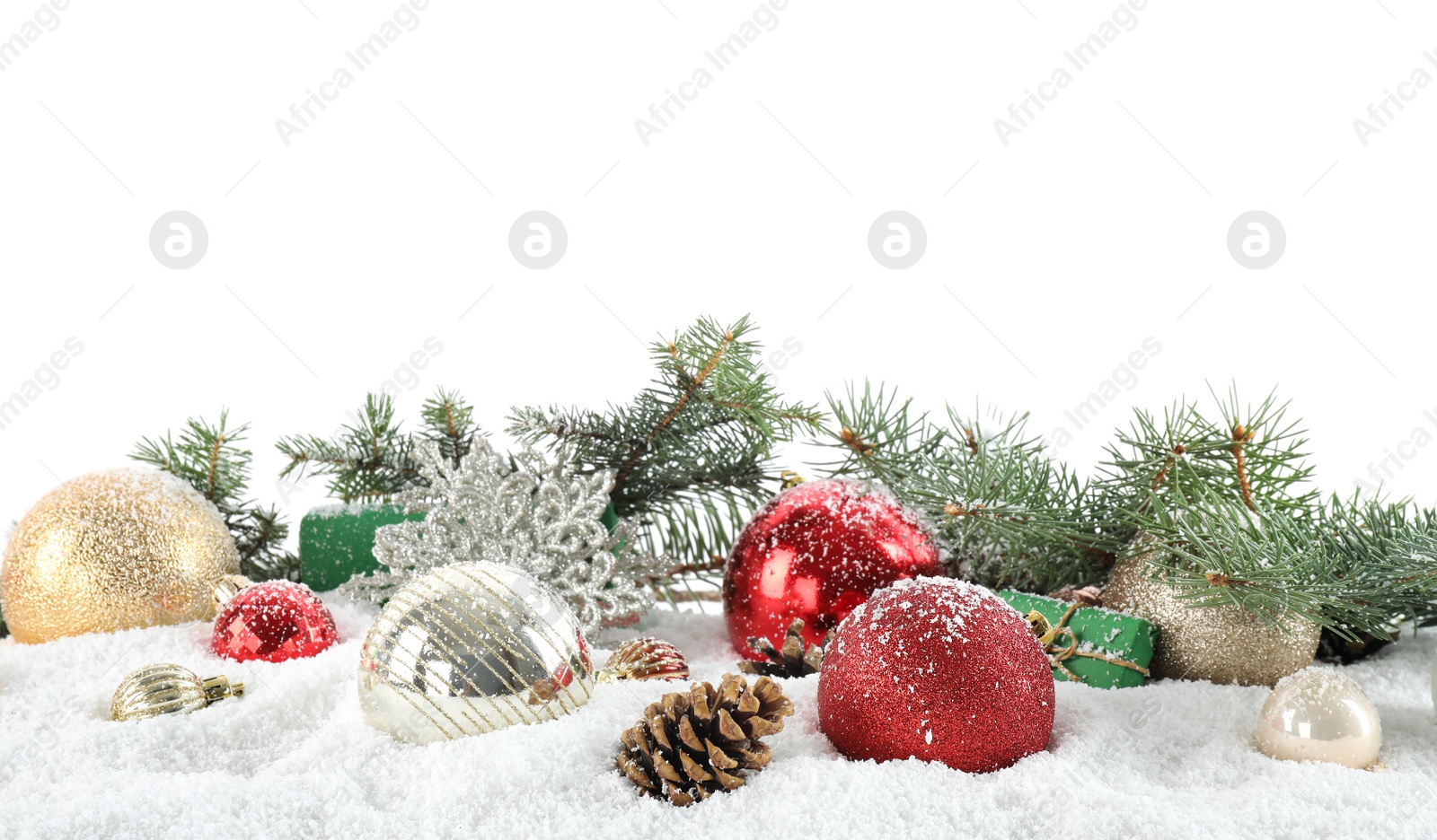 Photo of Fir branches, Christmas decoration and snow against white background