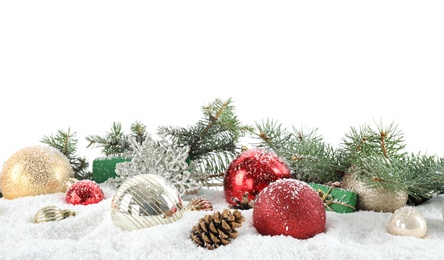 Fir branches, Christmas decoration and snow against white background