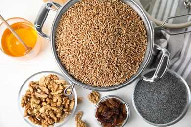 Ingredients for traditional kutia on white wooden table, flat lay