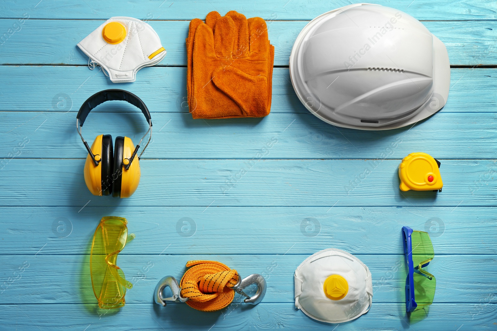 Photo of Flat lay composition with safety equipment and space for text on wooden background