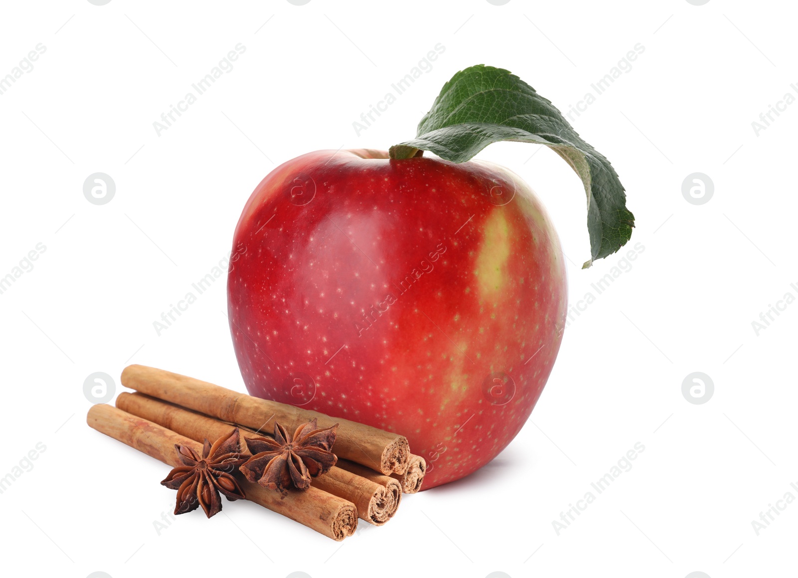 Image of Aromatic cinnamon sticks, anise stars and red apple isolated on white