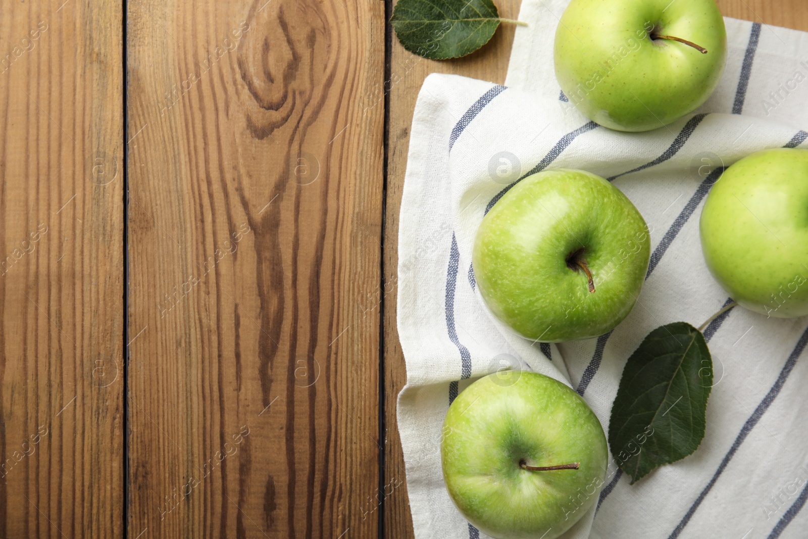 Photo of Flat lay composition of fresh ripe green apples on wooden background, space for text