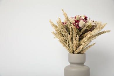 Photo of Beautiful bouquet of dry flowers in vase on white background, space for text