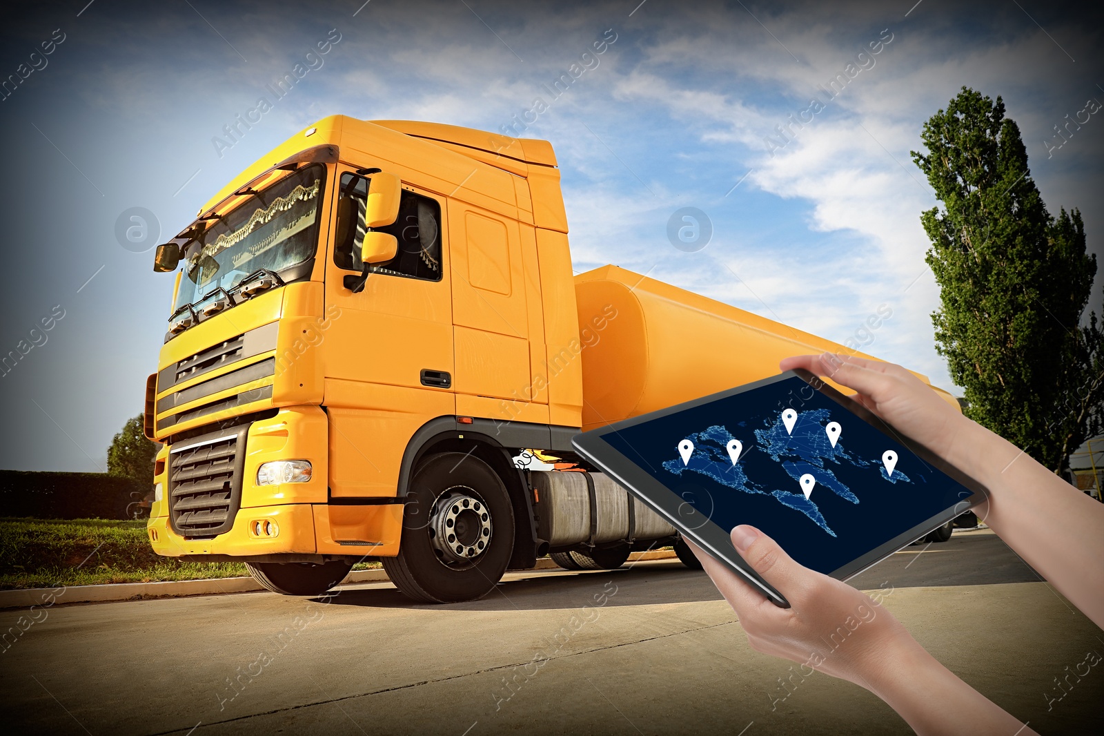 Image of Logistics concept. Woman using tablet with world map on screen against truck