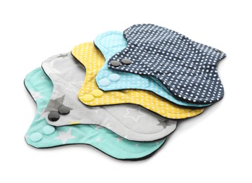 Photo of Many cloth menstrual pads on white background. Reusable female hygiene product