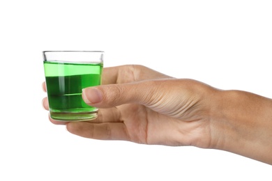 Photo of Woman holding glass with mouthwash for teeth care on white background