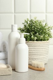 Photo of Different bath accessories and personal care products on gray table