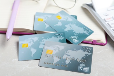 Photo of Credit cards and notebook on light grey marble table