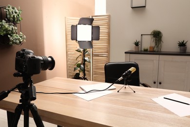 Photo of Modern blogger's workplace with professional equipment in room