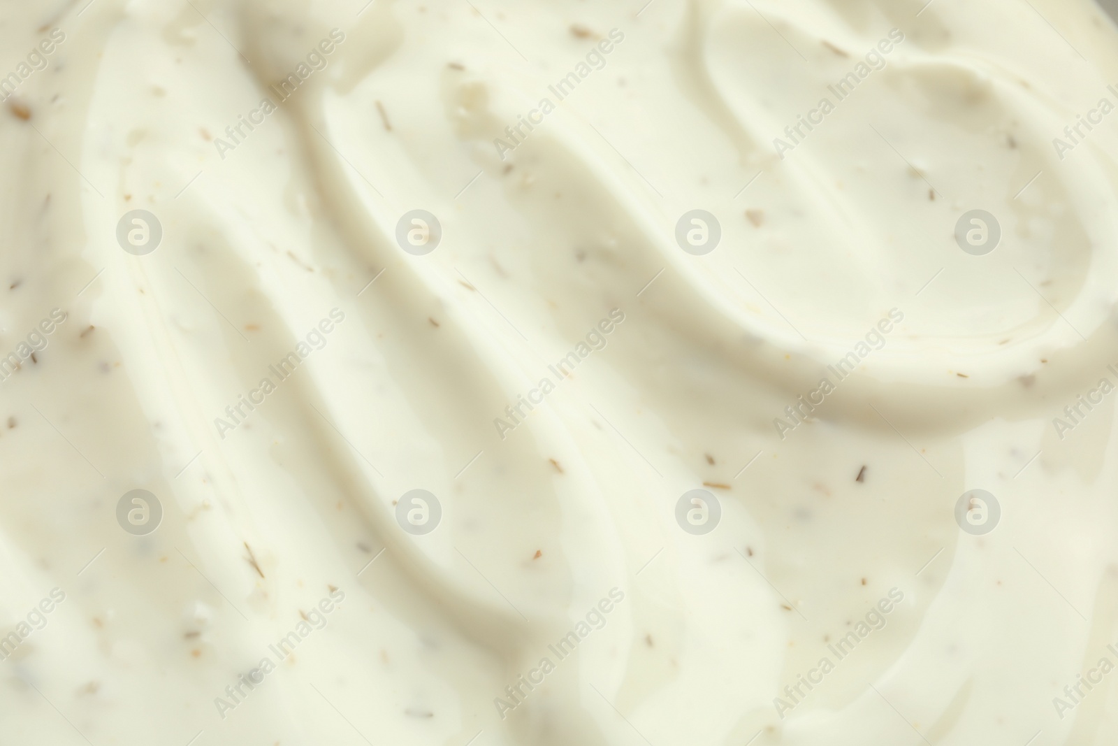 Photo of Tasty homemade garlic sauce as background, closeup