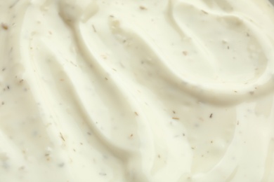 Photo of Tasty homemade garlic sauce as background, closeup