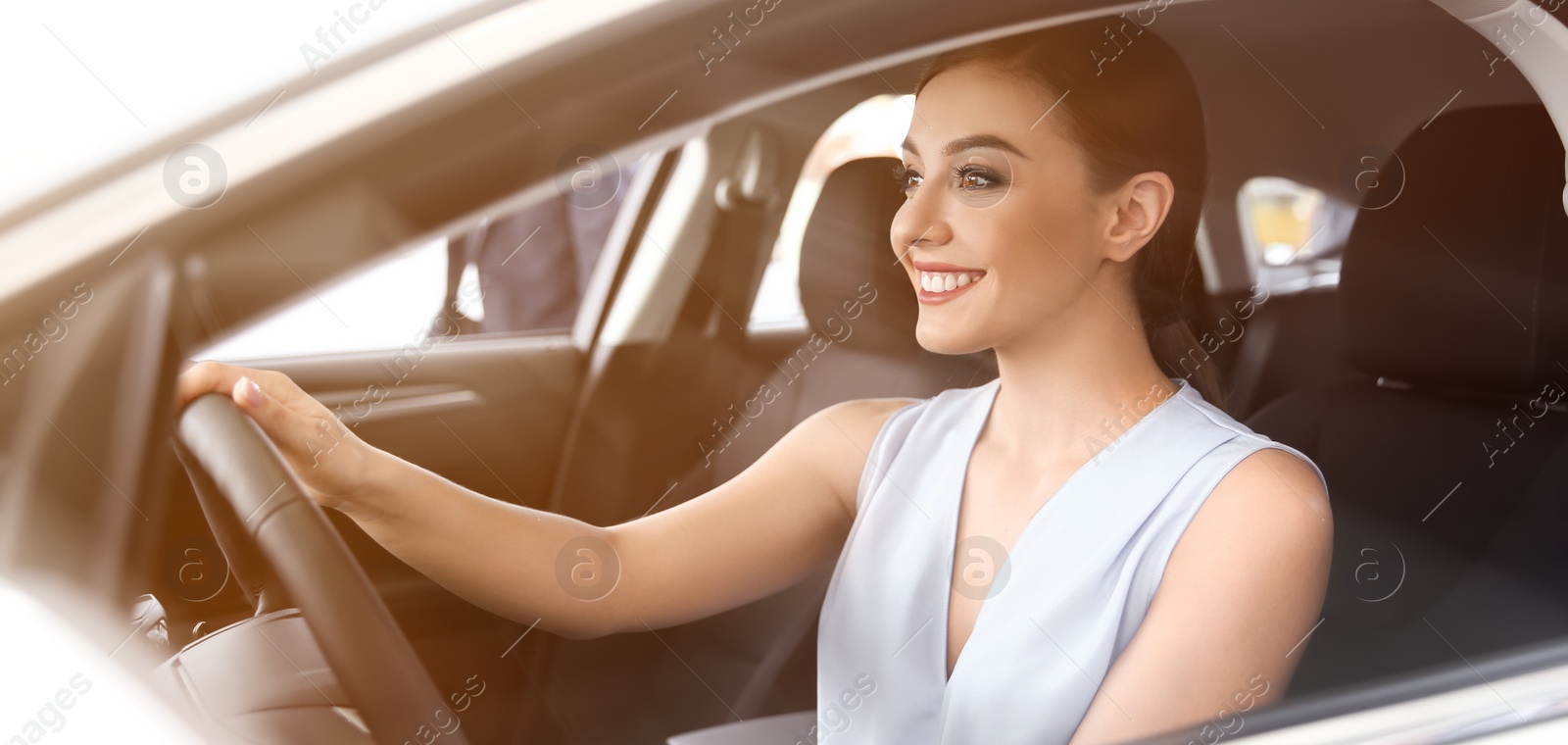 Image of Happy young woman driving modern car on sunny day. Banner design