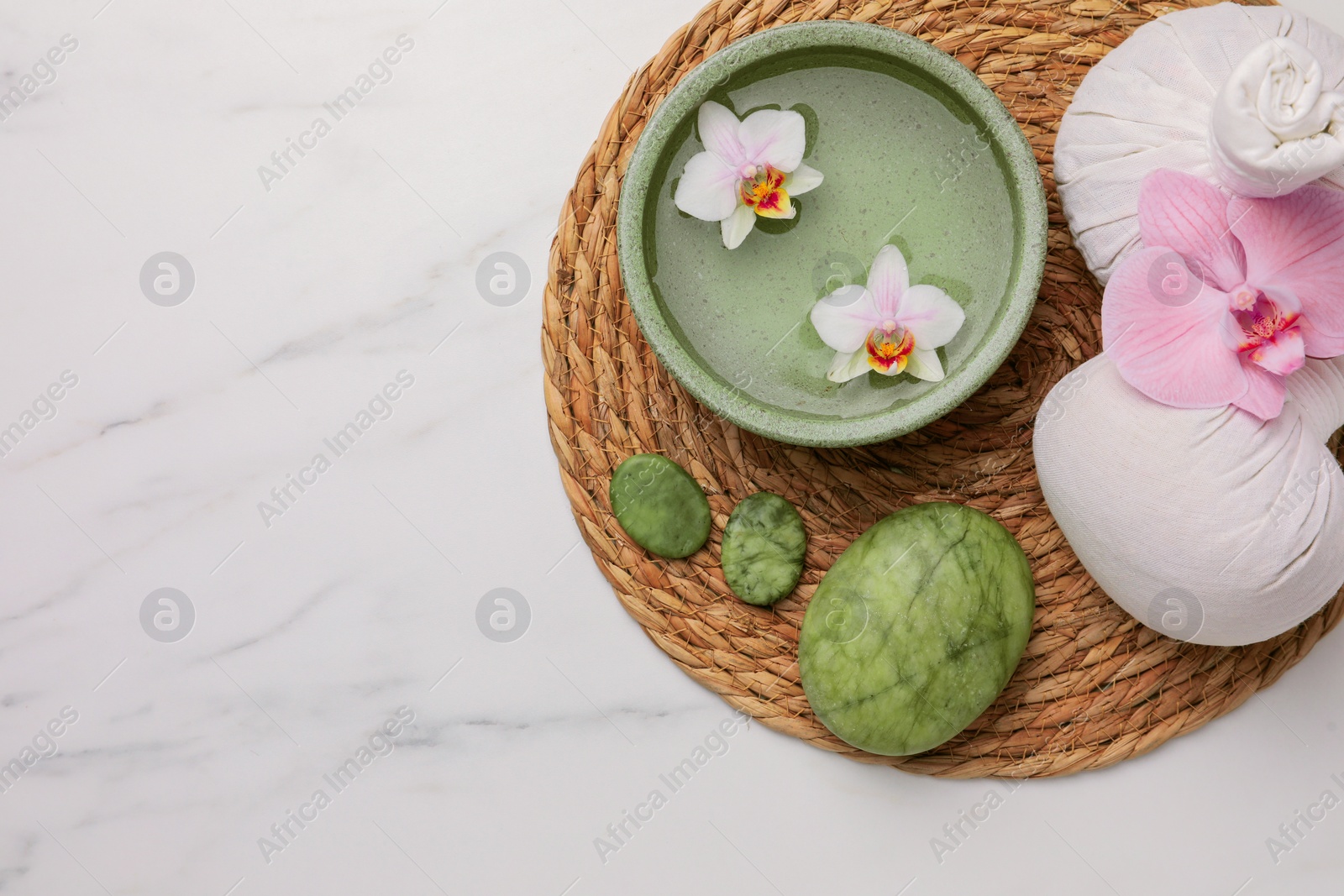 Photo of Composition with spa products and flowers on white marble table, top view. Space for text