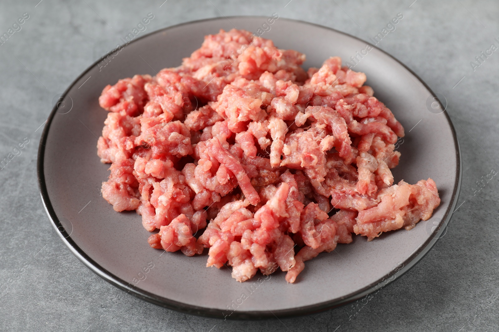 Photo of Raw ground meat on grey table, closeup